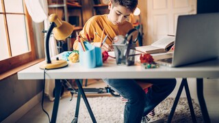 Schoolchild at a desk in the children's room