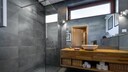 A modern bathroom with gray porcelain stoneware tiles
