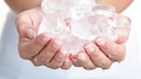 Woman Holds Ice Cube in Her Hand