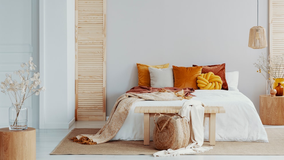 Colorful pillows on the bed in a neutral setting