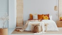 Colorful pillows on the bed in a neutral setting