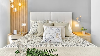 Various bedside lamps next to a bed
