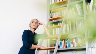 Woman on Ladder in Living Room