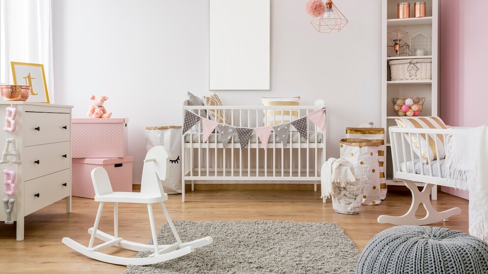 Children's room with white furniture and pink accents