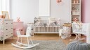 Children's room with white furniture and pink accents