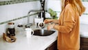 If a small amount of coffee grounds goes down the drain while washing dishes, it's generally not a cause for concern.