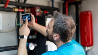 Man at Gas Connection with Various Pipes