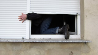 Burglar climbs through window