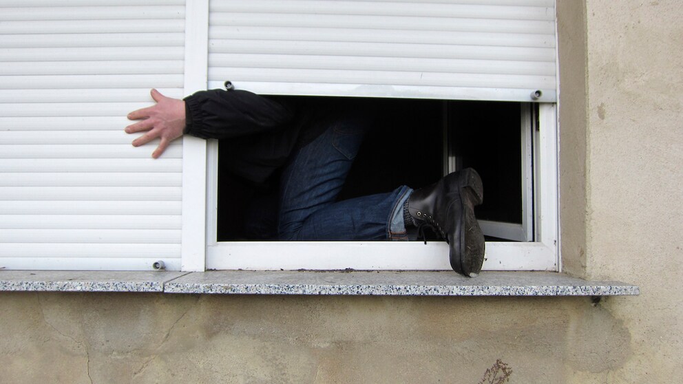 Burglar climbs through window