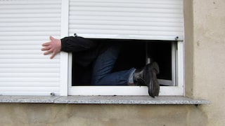 Burglar climbs through window