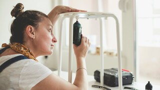 Woman Holding a Cordless Screwdriver