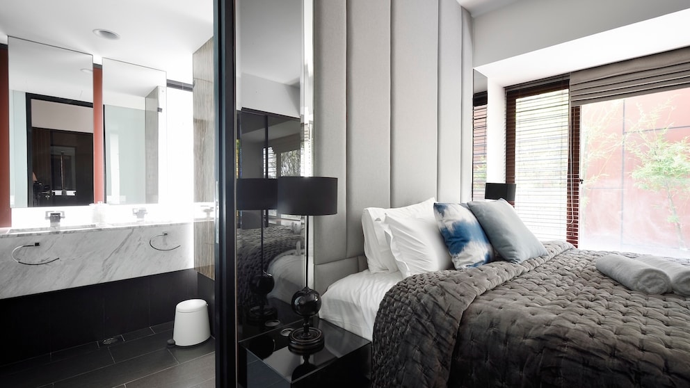 Considering combining your bedroom and bathroom? Here are a few things to keep in mind.