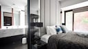 Considering combining your bedroom and bathroom? Here are a few things to keep in mind.