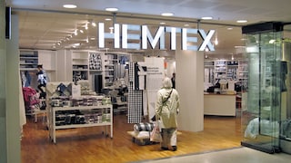Woman Stands in Front of a Hemtex Store