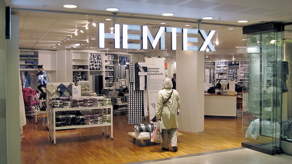 Woman Stands in Front of a Hemtex Store
