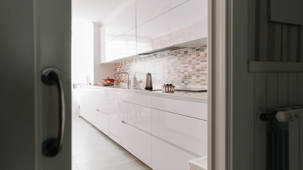 The back kitchen conceals chaos and kitchen appliances, keeping the open-plan kitchen tidy.