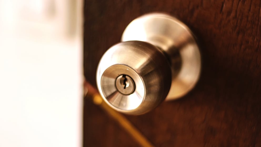 If you suspect that nitric acid might be on the door lock, you should call the police and avoid touching the lock.