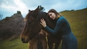 Woman stroking Icelandic horse
