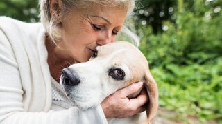 Older woman cuddles with her dog