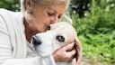 Older woman cuddles with her dog
