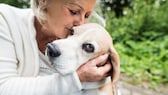 Older woman cuddles with her dog