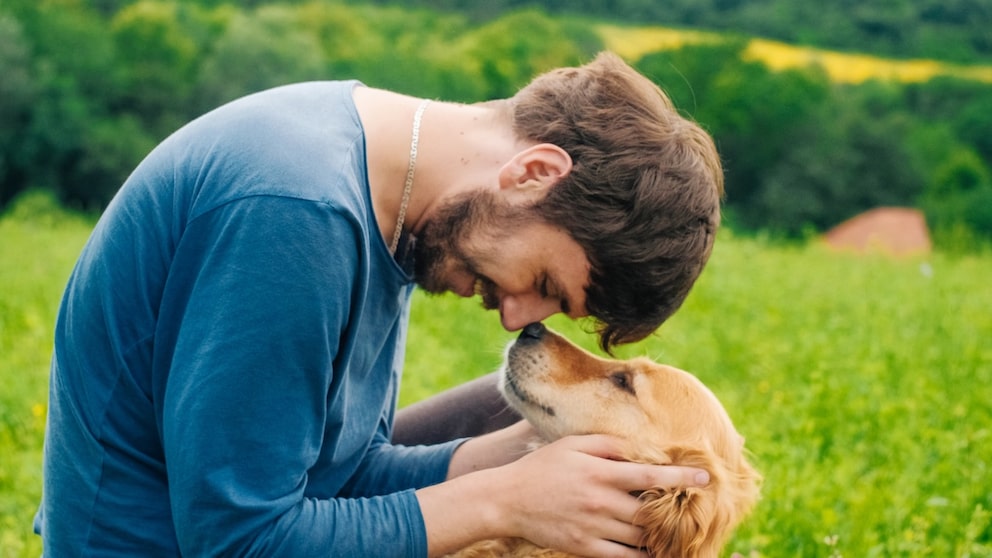 Man Cuddles With Dog