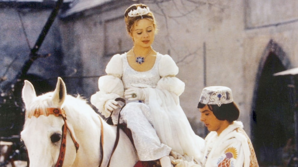 The white horse Nikolaus appears in numerous scenes in the film, accompanying Cinderella through forest and castle settings.