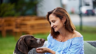 Carmen Borsche smiling while interacting with a dog