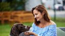 Carmen Borsche smiling while interacting with a dog