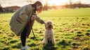Dog Owner with Dog on Meadow, Petting While Sitting