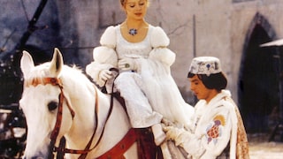 Scene from Three Hazelnuts for Cinderella, when Cinderella sits on the horse and the prince slips the shoe onto her foot