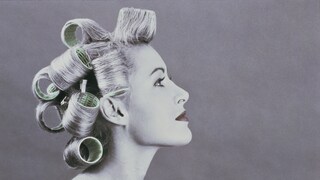 Black and white photo of woman with curlers