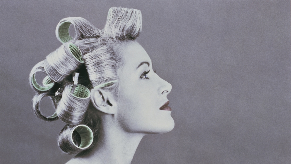Black and white photo of woman with curlers