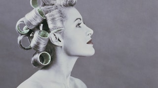 Black and white photo of woman with curlers