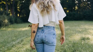 Woman with a fine tattoo on her arm