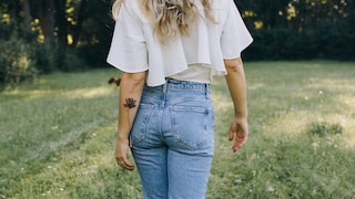 Woman with a fine tattoo on her arm