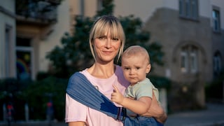 Woman around or over 40 with a baby. Both look very cute somehow. It's about late childbearing and I apologize from the bottom of my heart if I make the lady here look older than she is.