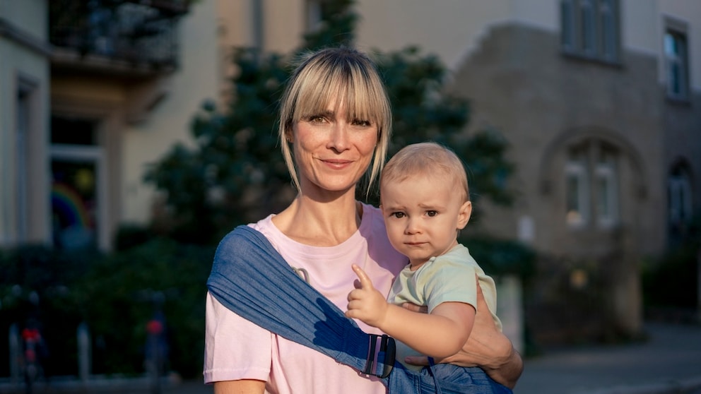 Woman around or over 40 with a baby. Both look very cute somehow. It's about late childbearing and I apologize from the bottom of my heart if I make the lady here look older than she is.