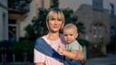 Woman around or over 40 with a baby. Both look very cute somehow. It's about late childbearing and I apologize from the bottom of my heart if I make the lady here look older than she is.