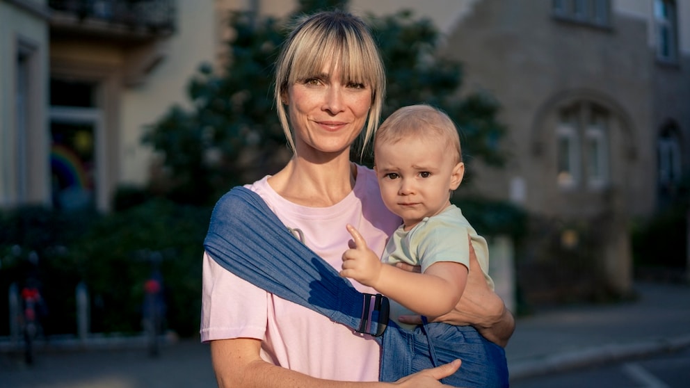 Woman around or over 40 with a baby. Both look very cute somehow. It's about late childbearing and I apologize from the bottom of my heart if I make the lady here look older than she is.