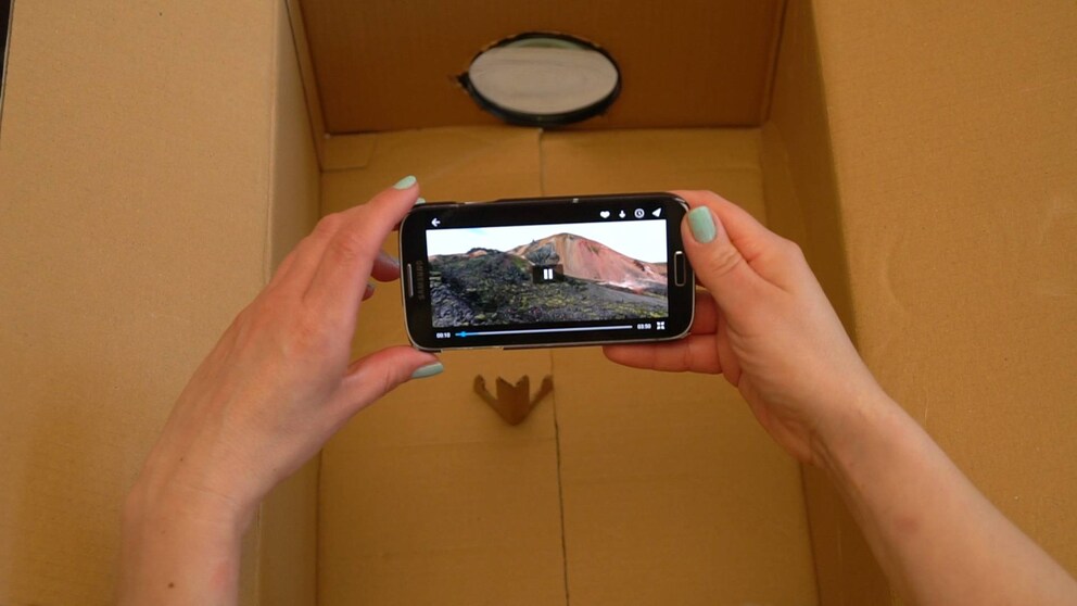 With a cardboard box and a magnifying glass, you can turn your smartphone into a projector.