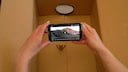 With a cardboard box and a magnifying glass, you can turn your smartphone into a projector.