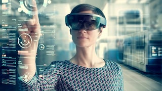 Woman with Microsoft HoloLens behind projected screen