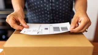 Woman Stamps a Package