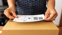 Woman Stamps a Package