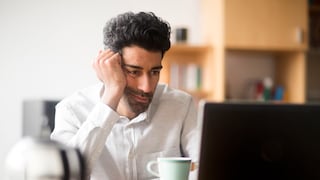 Man Frustrated in Front of Laptop