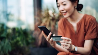 Woman Makes International Transfer via App Using Smartphone and Credit Card