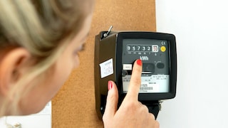 Kilowatt-hour Meter: Woman Reads Values