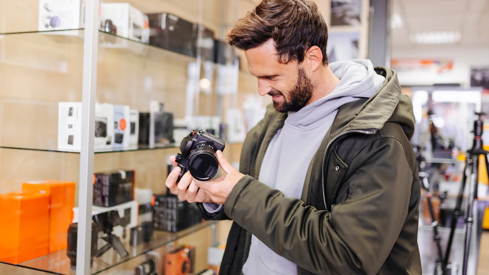 Man Looks at a Camera in the Store