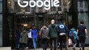 Several people enter the Google headquarters, with the logo prominently displayed above them. Google knows a lot about its users because it sells their data for advertising purposes.
